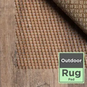 Outdoor area rug pad under a patterned outdoor rug