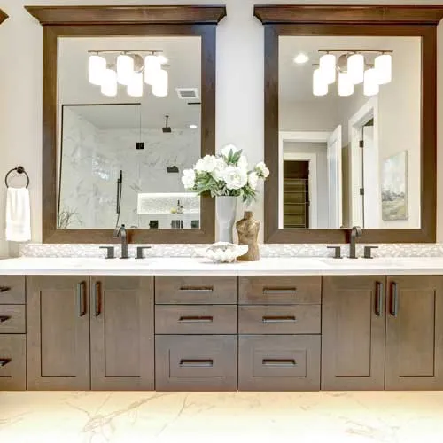 Remodeled bathroom with tiled shower and vanity cabinetry